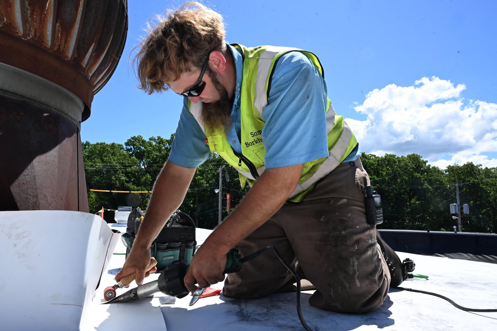 Green Improvements roofer fitting roofing membrane around a roof penetration