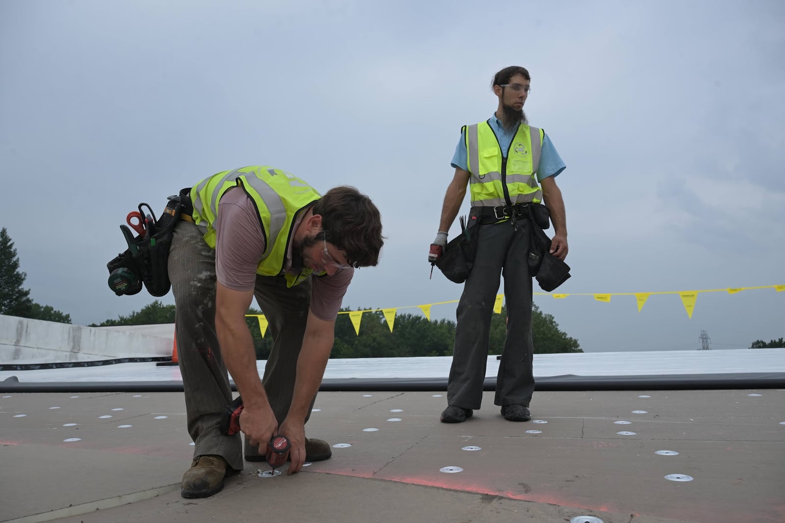 Green Improvements crew examining the surface of a commercial roof