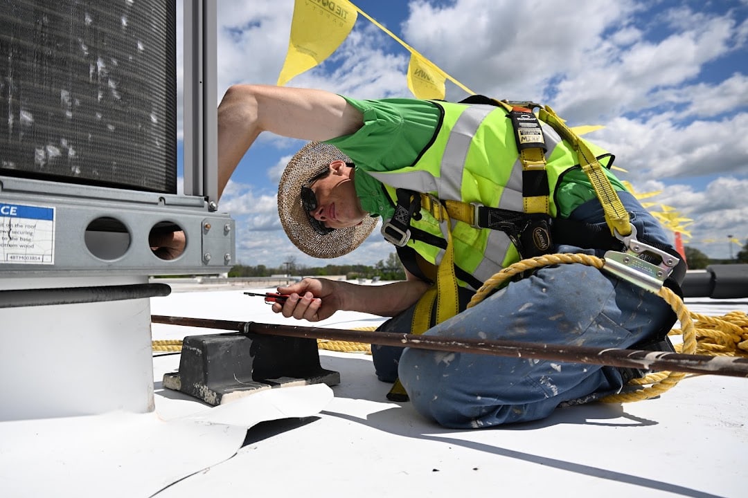 Green Improvements roofer fitting membrane around rooftop equipment