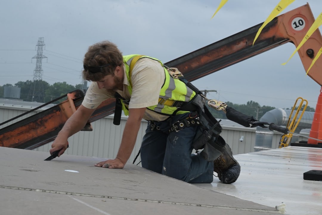 Green Improvements roofer positioning board on a commercial roof