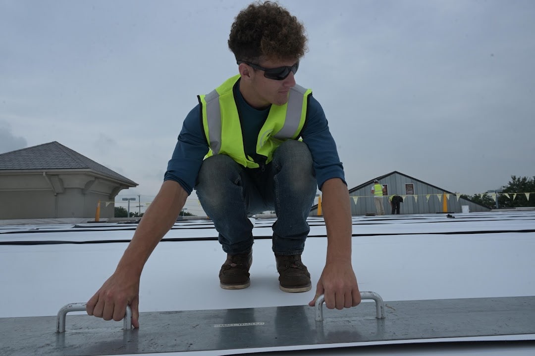 Green Improvements roofer working along a roof surface joint